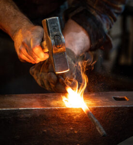Une barre de fer est forgée dans le cadre de la restauration de la porte de la Reine patrimoniale du Parlement. (Crédit photo : Services publics et Approvisionnement Canada)